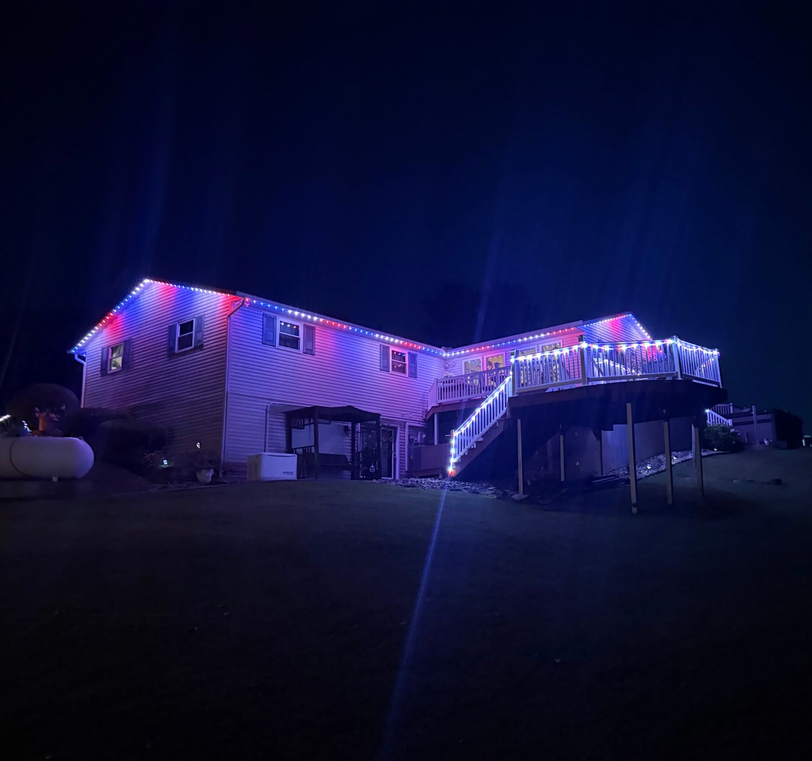 Permanent roofline and deck lighting installed by Winter Glow Holiday Lights