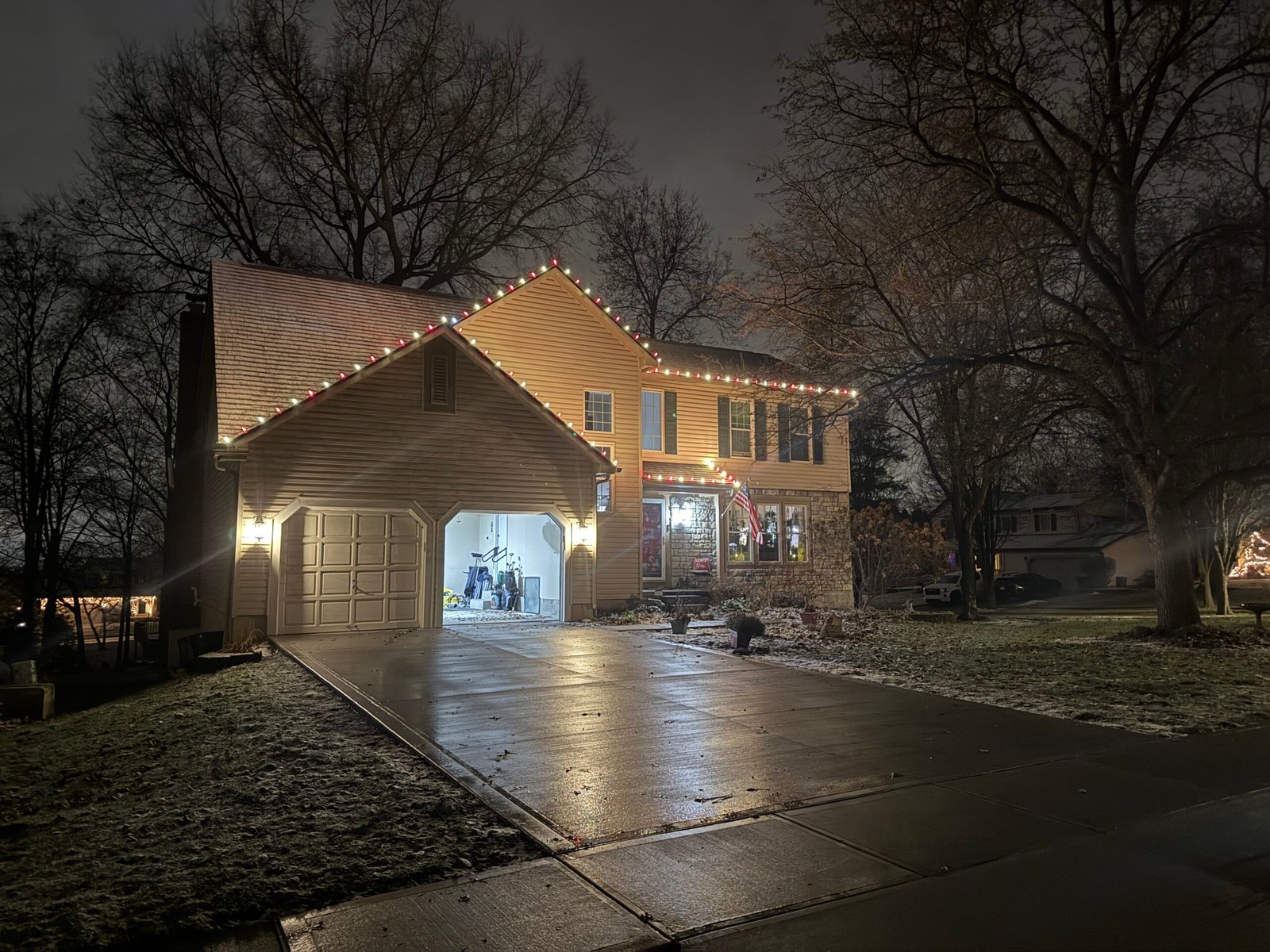 Multicolored roofline lights and warm white Christmas porch lighting