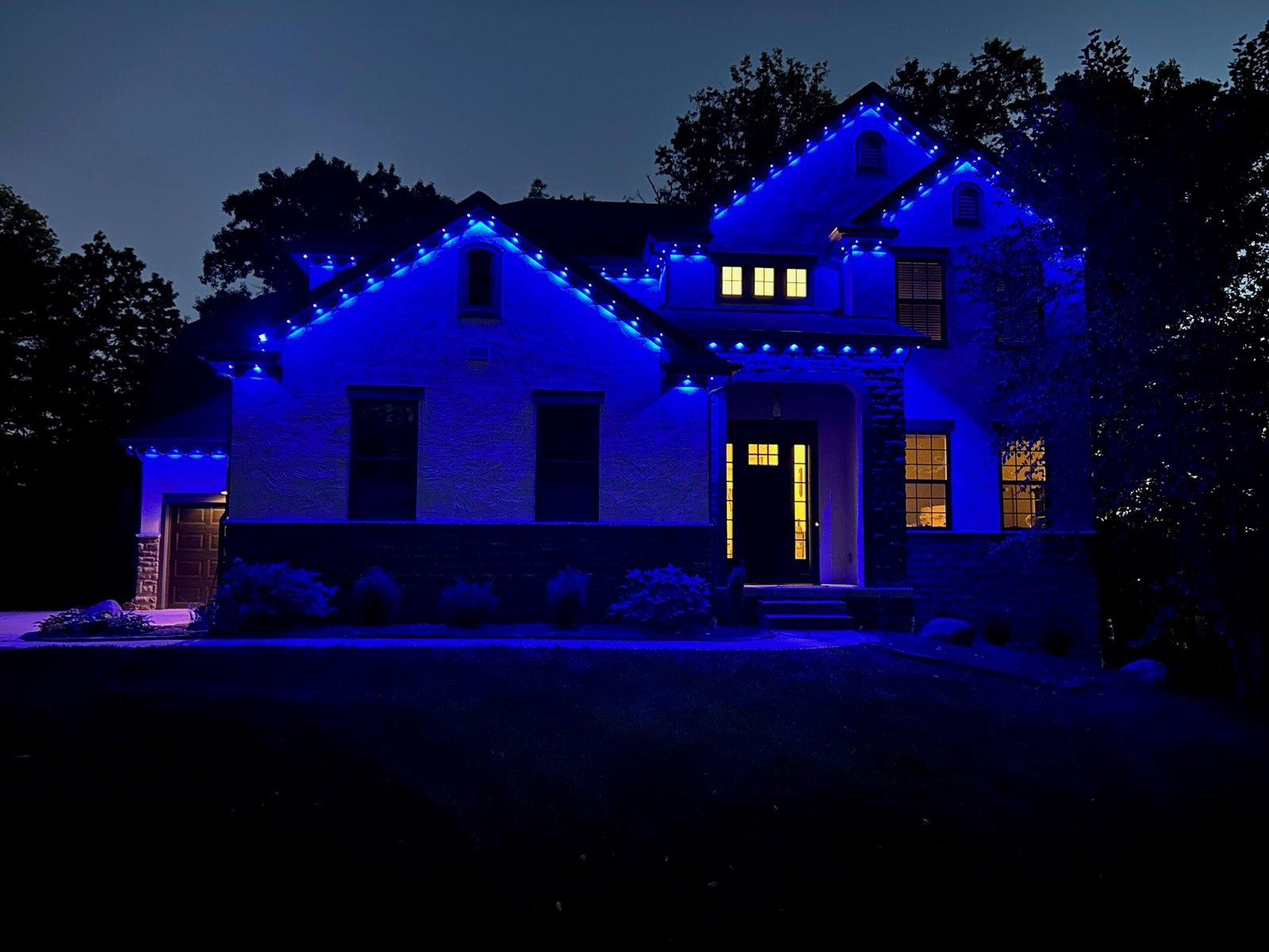 Permanent architectural lighting installation illuminated in blue on a Columbus Ohio home