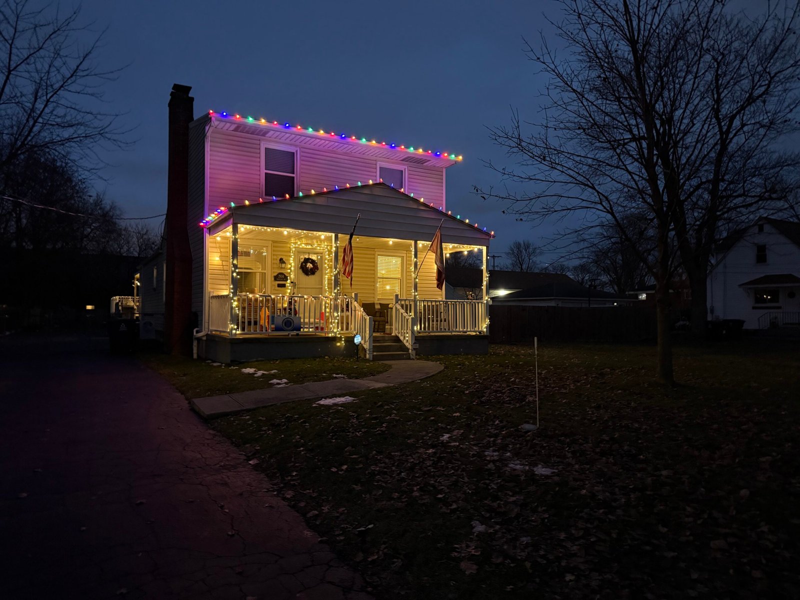 Multicolor roofline and warm white porch Christmas lights installed by Winter Glow Holiday Lights